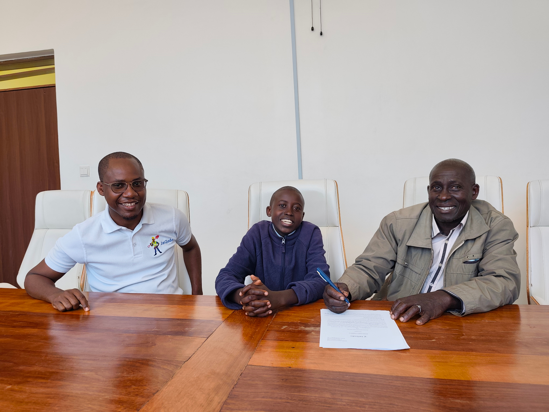 Scholarship signing moment with student and guardian