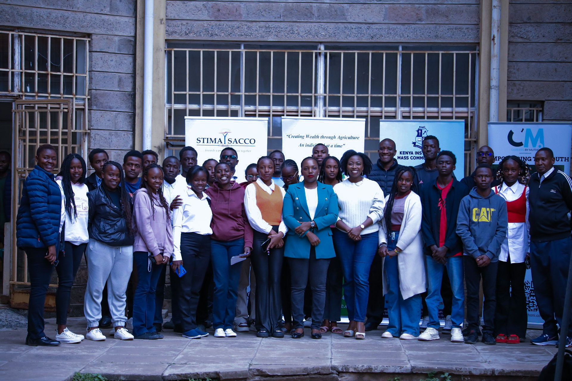 Cohort group photo with partner banners