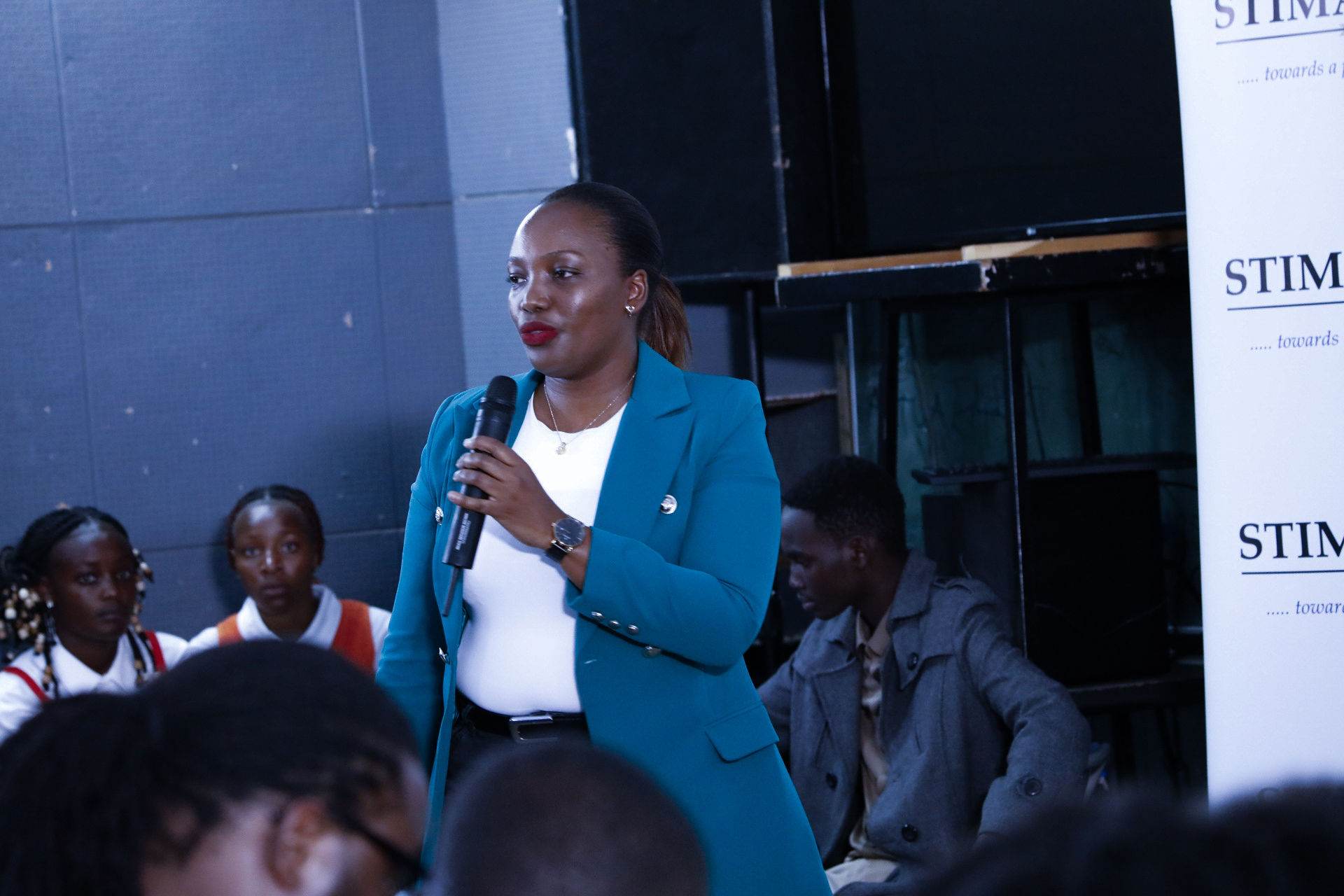 Mentor addressing students with a microphone